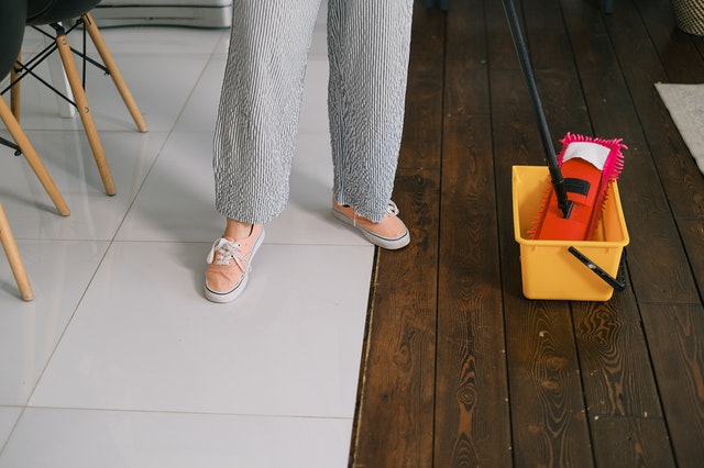 A woman mopping the floors.