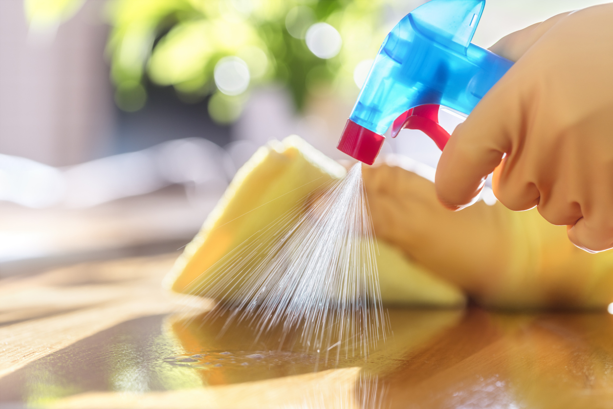 Woman cleaning home using natural cleaning products