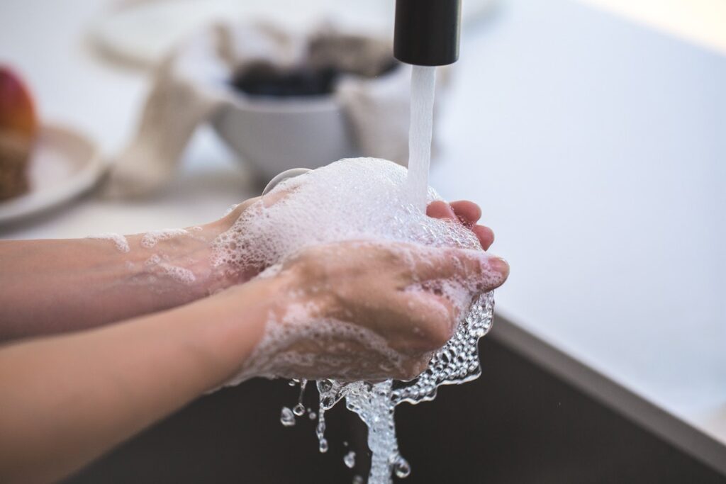 A person washing hands.