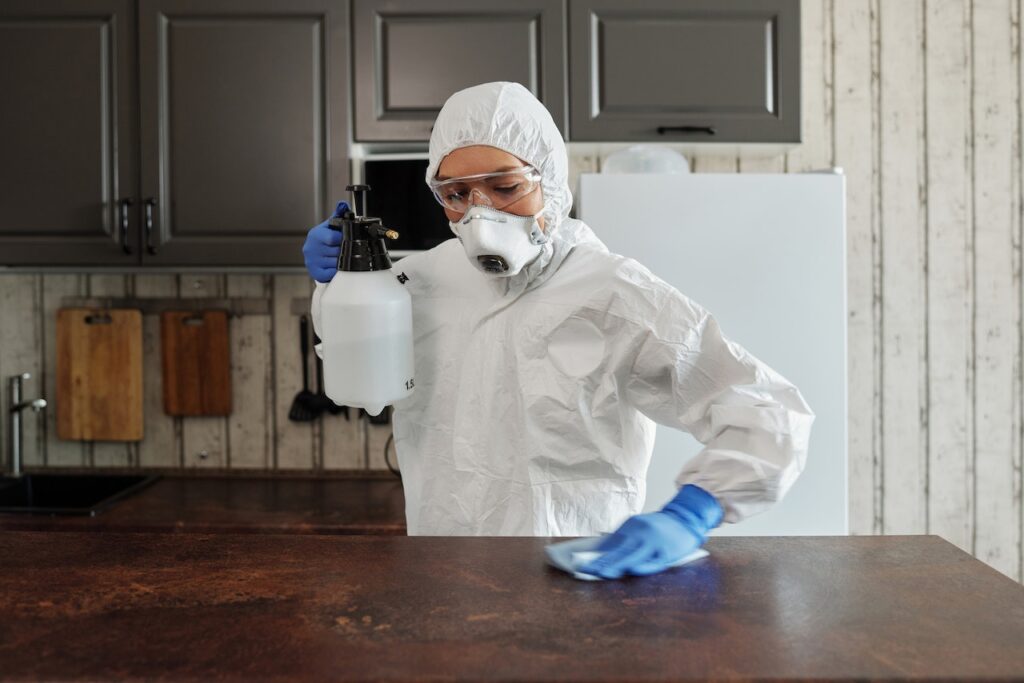 A person cleaning the kitchen surface