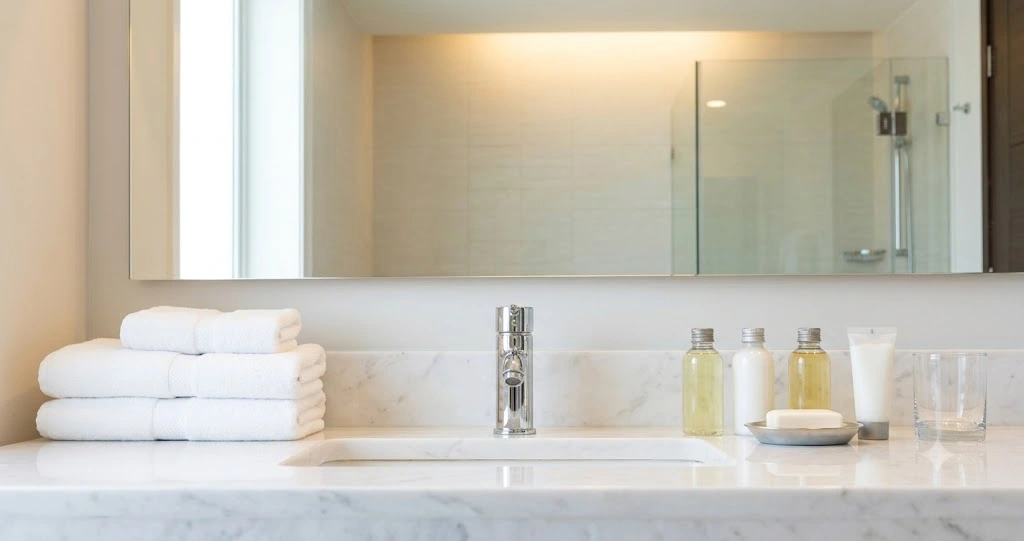 Airbnb turnover cleaner preparing bedroom between guest stays